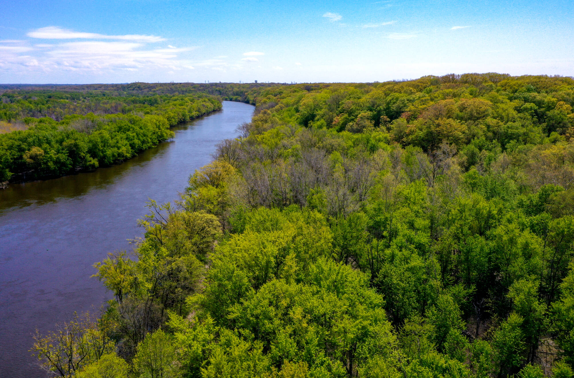 An aerial view shows the spring landscape of the Ravines and the Grand River on the Valley Campus